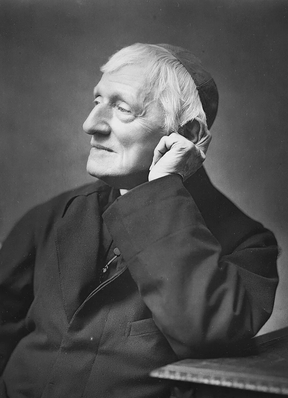 Cardinal Newman in old age, in profile, resting his head on his hand
